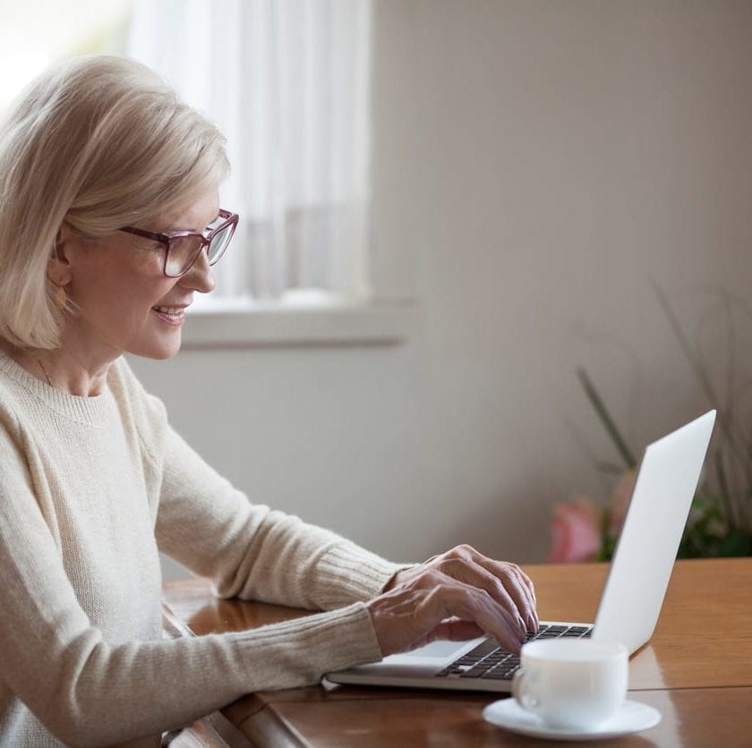 An older woman using a laptop